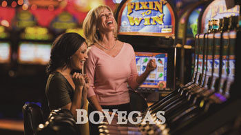 Realtime Gaming Two woman enjoy playing slots